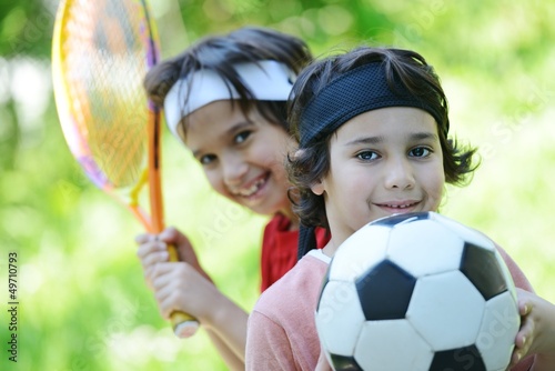 Photo: Young boys with football and tennis outside Young boys with football and tennis outside