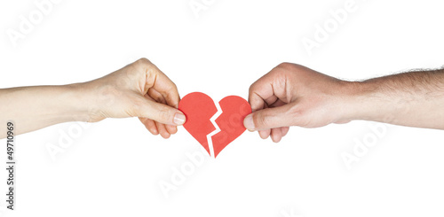 Photo: Man and woman hands holding broken heart Man and woman hands holding broken heart