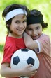 Young boys holding football outside