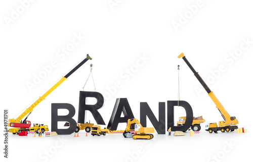 Photo: Brand start up: Machines building brand-word. Brand start up: Machines building brand-word.