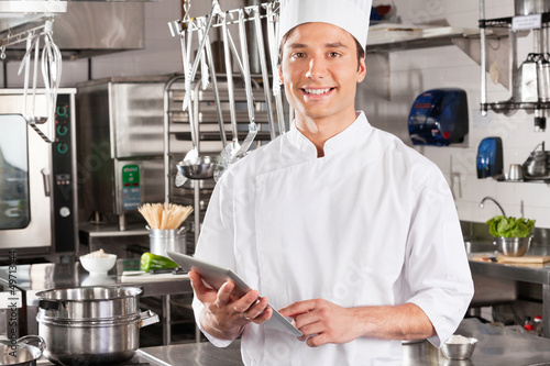Photo: Happy Chef Holding Tablet Computer Happy Chef Holding Tablet Computer
