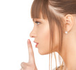 happy woman with finger on lips