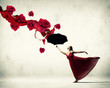 Ballet dancer in flying satin dress with umbrella