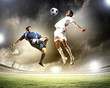 two football players striking the ball