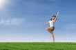 Attractive woman gesture on green field