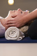 Photo: Young therapist arranging crystals on female client for reiki th Young therapist arranging crystals on female client for reiki th