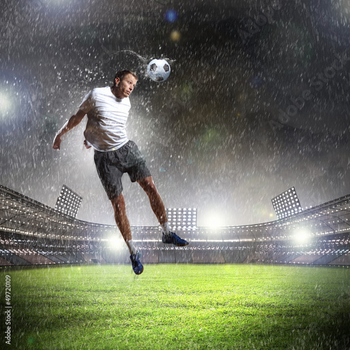 Photo: football player striking the ball football player striking the ball