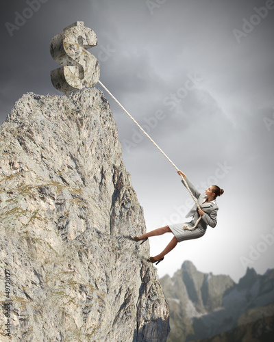 Photo: businesswoman climbing mountain businesswoman climbing mountain