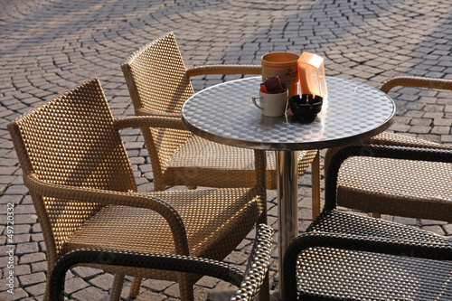 Photo: outdoor coffee table with some chairs in the middle of the pedes outdoor coffee table with some chairs in the middle of the pedes