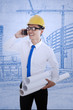 Happy engineer calling friend