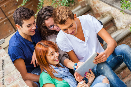 Photo: Group of Teenage Friends with Tablet PC Group of Teenage Friends with Tablet PC