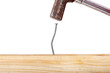 Crooked nail in the wooden board with a hammer