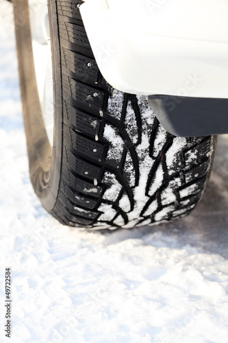 Photo: Car wheel on a white snow Car wheel on a white snow