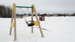 empty colorful swing seat move winter snow beach playground