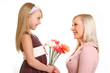 Daughter gives her mother flowers isolated on white background
