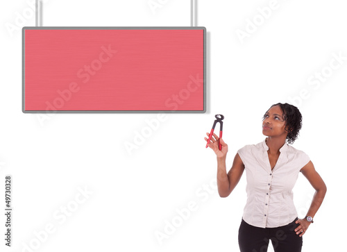 Photo: Young african american woman looking to unhook a empty board Young african american woman looking to unhook a empty board
