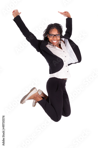 Photo: Young african american business woman jumping, success concept Young african american business woman jumping, success concept