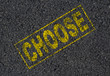 Choose stamped on asphalt background