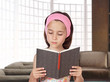 Photo: Little girl reading a book Little girl reading a book