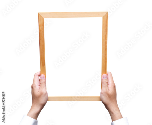 Photo: Hand holding wooden frame isolated on white Hand holding wooden frame isolated on white