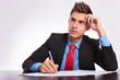 man at desk thinking what to write