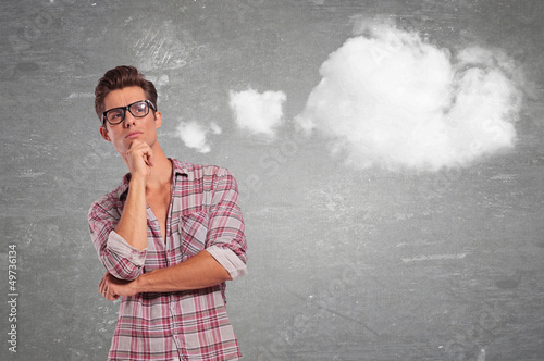 Photo: casual man with glasses thinking casual man with glasses thinking