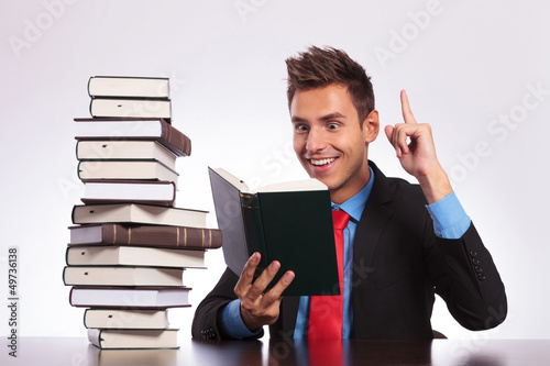 Photo: reading man has an idea at desk reading man has an idea at desk