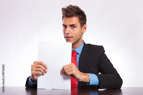 Photo: man at desk looks at you man at desk looks at you
