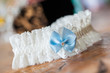 Photo: A white linen garter with a blue bow. A white linen garter with a blue bow.