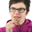 Photo: Woman eating biscuit Woman eating biscuit