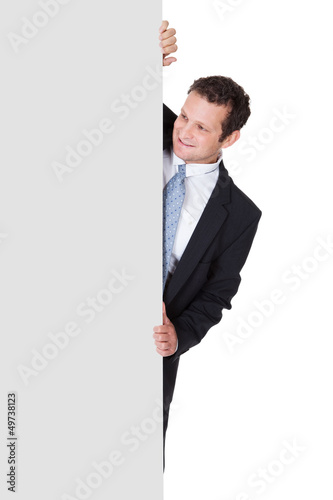 Photo: Successful businessman presenting empty banner Successful businessman presenting empty banner