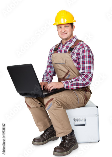 Photo: Construction worker with laptop Construction worker with laptop