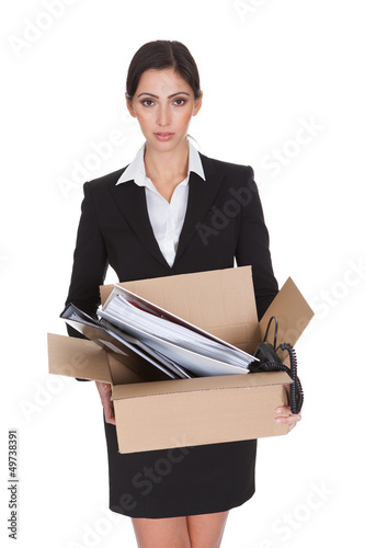 Photo: Young Business Woman Holding A Box Of Documents Young Business Woman Holding A Box Of Documents