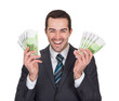 Excited businessman holding euro notes
