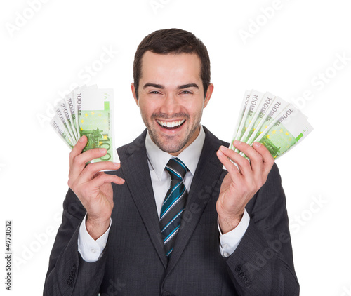 Photo: Excited businessman holding euro notes Excited businessman holding euro notes
