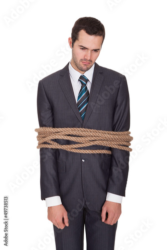 Photo: Businessman tied up in rope Businessman tied up in rope