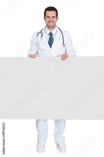 Photo: Happy Male Doctor Holding Empty Placard Happy Male Doctor Holding Empty Placard