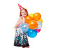 happy redhead girl in dress and holiday hat with balloons