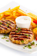 Grilled steaks, French fries and vegetables