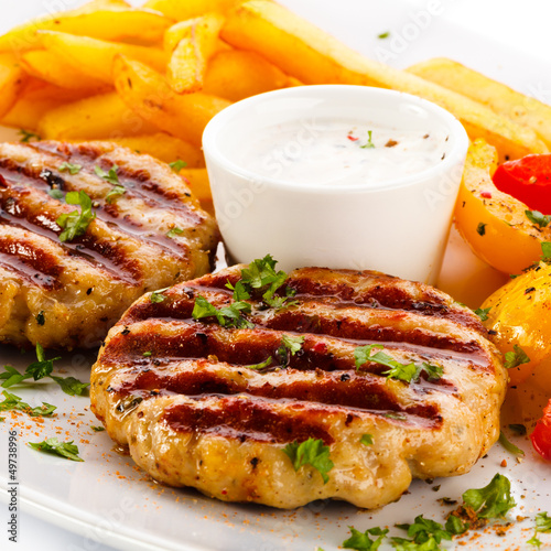 Photo: Grilled steaks, French fries and vegetables Grilled steaks, French fries and vegetables