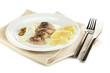 Dish of herring and lemon on plate isolated on white