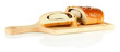 Loaf with poppy seeds on cutting board, isolated on white