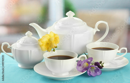 Photo: Beautiful tea service on table Beautiful tea service on table