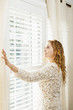 Smiling woman looking out window