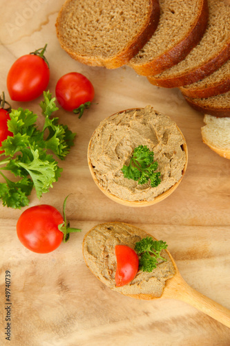 Photo: Fresh pate on wooden spoon, on wooden background Fresh pate on wooden spoon, on wooden background