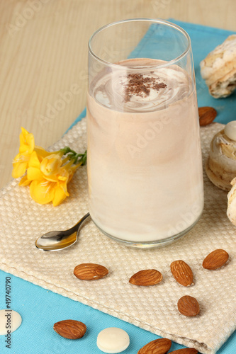 Photo: Glass of chocolate-cream cocktail on wooden table close-up Glass of chocolate-cream cocktail on wooden table close-up