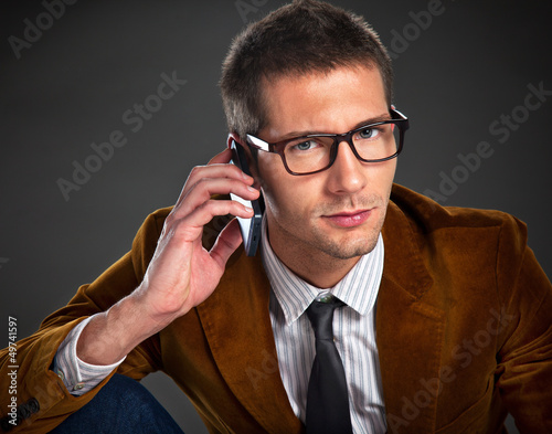 Photo: Young interesting businessman talking on phone Young interesting businessman talking on phone