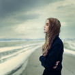 beautiful young woman on a cloudy day on the road