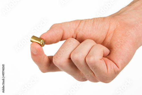 Photo: Hand holding an empty bullet shell Hand holding an empty bullet shell