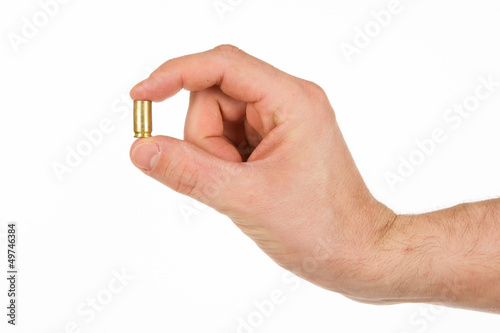 Photo: Hand holding an empty bullet shell Hand holding an empty bullet shell